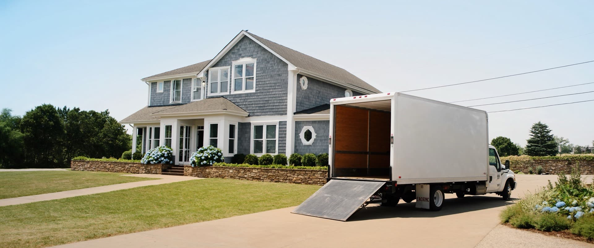 A moving truck in a Cape Cod driveway